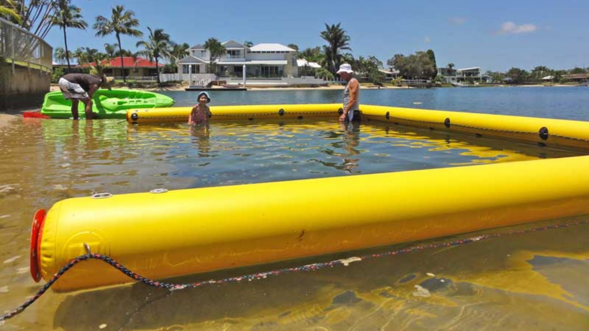 High-visibility beach boom with yellow floats and secure anchoring system.